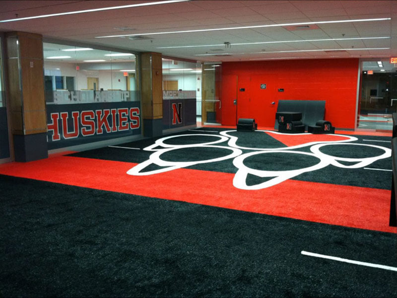 Nebraska Huskies logo made with indoor sports turf at training gym