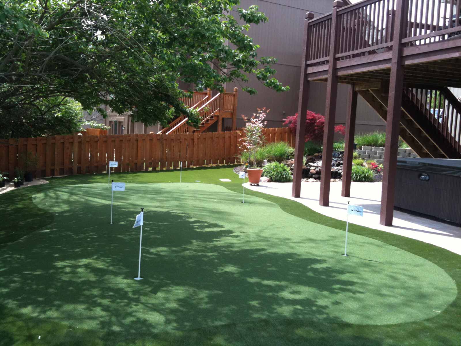 Large backyard putting green with six holes for customer Marty Albertson in Missouri