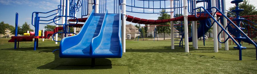SYNLawn Tramplezone featured underneath double blue slide at Kansas playground