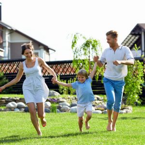 Family running on artificial grass in Kansas City