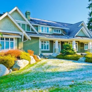 Beautiful Home with its artificial lawn covered in snow patches 