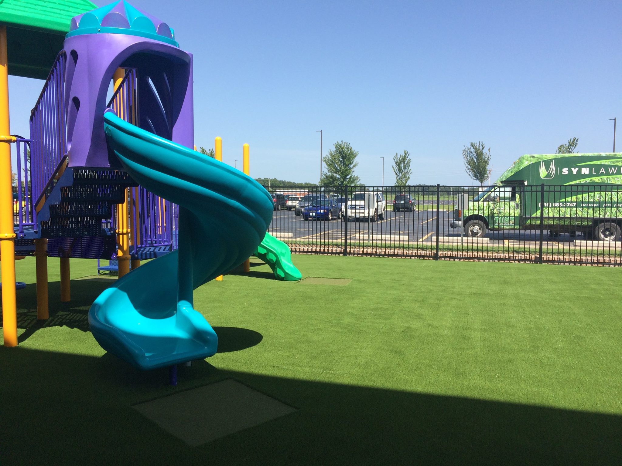 A colorful playground on SYNLawn artificial grass.