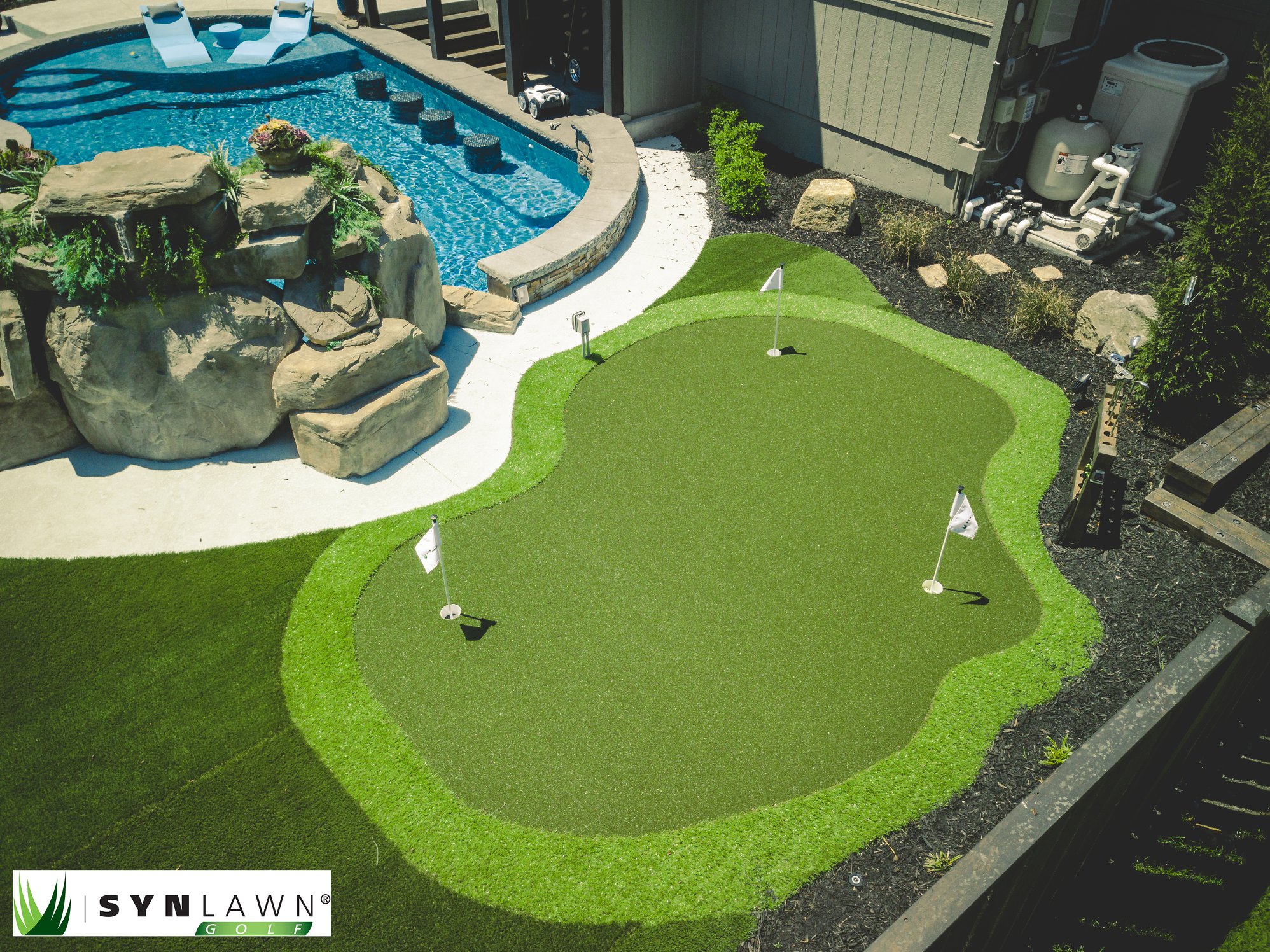 Kansas City backyard with an artificial grass putting green and pool.