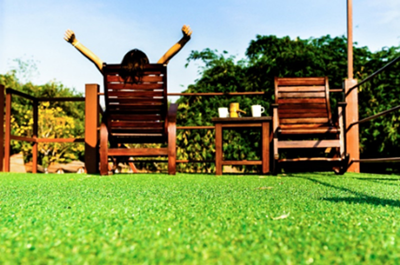 Woman relaxing on Kansas artificial lawns
