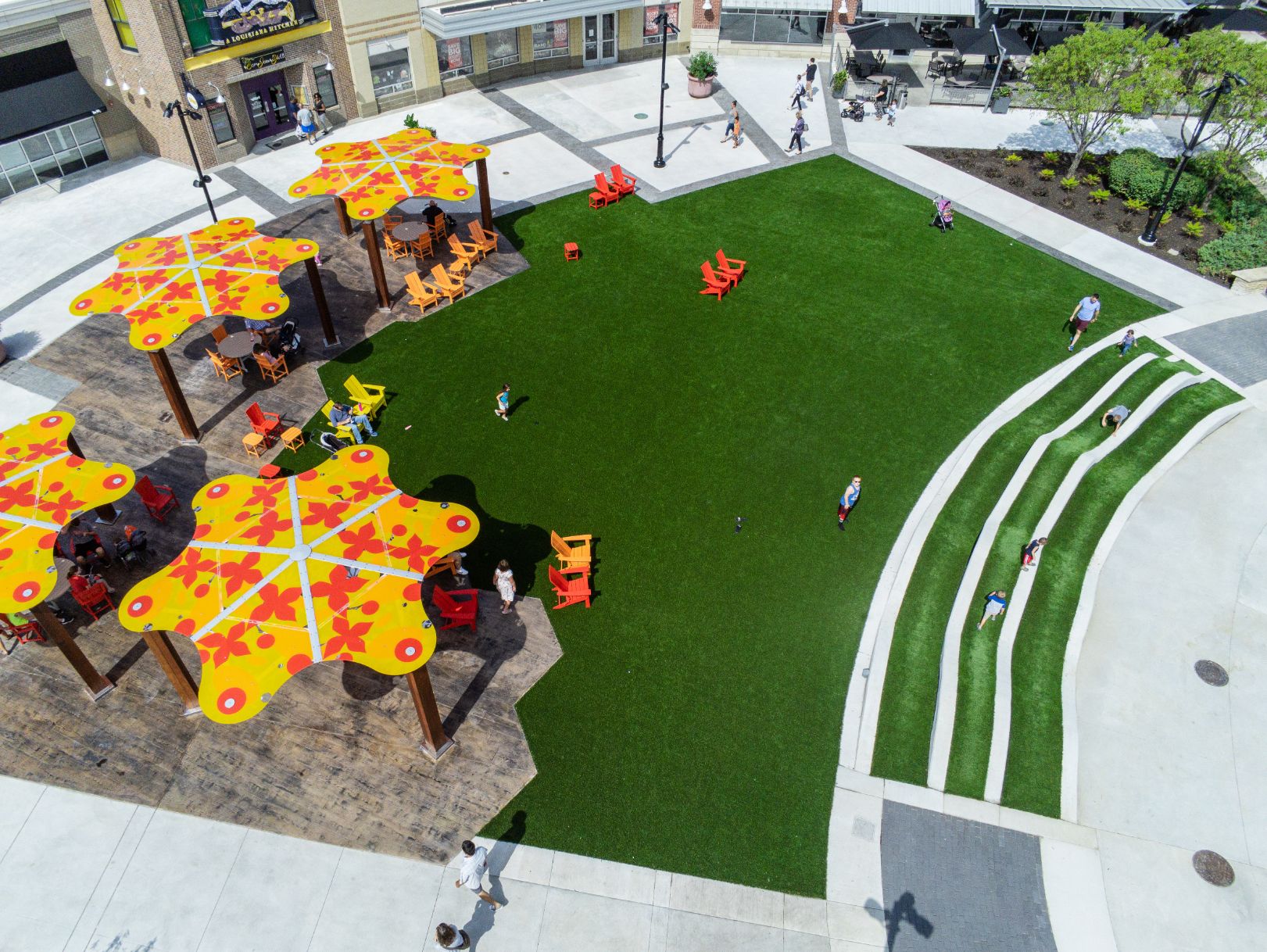 artificial grass common area in front of row of businesses